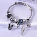 Adjustable stainless steel wire bracelet featuring owl, feather, and crystal bead charms - Black