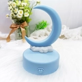 Blue crescent moon and cloud night light on circular base with a heart-shaped button - Blue