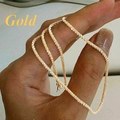 Minimalist gold starry chain necklace with shimmering texture held in hand - Necklace / Gold
