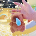 Close-up of brown plush capybara keychain with a creative blue bubble on the nose - Runny Nose Dark Brown + Silver Clip