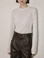 Detail of white bamboo texture knit top paired with dark brown faux leather trousers - XS / White