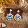 Ocean-themed earrings with gold whale and blue enamel charms on a sandy beach setting - Blue-Green Gradient Whale Pearl Dangle