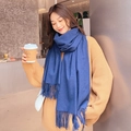 Close-up of blue cashmere-like scarf featuring soft thick texture and fringe details - Denim Blue