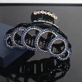 Black rhinestone hair claw clip with blue and iridescent wave patterns on reflective surface - Blue Iridescent Rhinestones