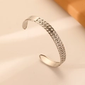 Detail of silver stainless steel cuff showing smooth band and braided chain texture - Silver Woven