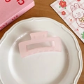 Matte light pink square hollow hair claw clip placed on a white ceramic plate - Amethyst