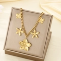 Close-up of a golden flower pendant necklace in a premium gift box on silk - Five Gold 3D Flower Pendants (KN296050-SXSJ)