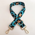Close-up of adjustable leopard print nylon bag strap with polished gold hardware - Silver Clasp / Aqua