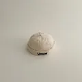Children's cream-white cotton skullcap with 'Unice' bold embroidery on the brim - Smiley Face Letter Style / One Size / Off White