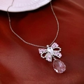 Detailed view of a silver bow necklace with pink crystal water drop pendant on red silk - 41# Necklace-Silver-Pink