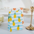 Mini paper gift bags featuring pineapple and orange prints for elegant party packaging - Pineapple