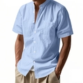 Detail of light blue linen shirt featuring a standing collar and buttoned chest pocket - Light Blue