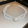Detail of double-layer pearl necklace featuring a diamond-encrusted central pendant - White Pearl