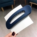 Dark blue minimalist hollow oval hair clip on a white display card held by hand - Navy Blue