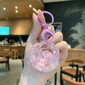 Roze hars roos sleutelhanger met paars verloop drijfzand en een matte metalen ring - Kleine Rozenbloem / Paars