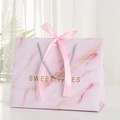 Pink marble gift bag with silk ribbon bow and golden Sweet Times typography - Pink Sweet Times