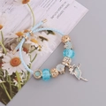 Sky blue braided leather bracelet with crystal butterfly charm and ballet dancer pendant - Lake Blue