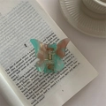 Detailed view of an acetate butterfly hair claw clip with pink and green gradient finish - Lake Green