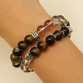 Brown tiger eye and tea crystal beaded bracelets with silver floral charms on a wrist - Smoky Quartz and Tiger Eye Bracelet Style (A-1210)