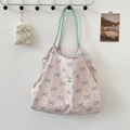 Detail of pink canvas tote bag featuring green bow prints and braided rope handles - Pink with Green Bowknot