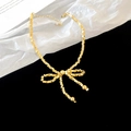 Macro detail of golden bow necklace with metallic beads on black and white background - Gold Bowknot Square Bead Bracelet