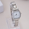 Detailed close-up of a square silver quartz watch with white dial on acrylic stand - WT022 Silver White Square