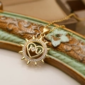 Macro shot of gold sunburst heart pendant with I-Love-U engraving and clear crystals - Sunburst Pendant