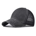 Detail showing distressed holes on brim and breathable mesh of black cotton trucker hat - Adjustable / Black