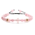 Pink natural stone cross beaded bracelet with black adjustable woven rope and gold accents - Rose Quartz