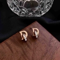 Rose gold letter D earrings with pavé zircon ring detail on a luxury wood display - Earrings / Rose Gold Letter D Earrings