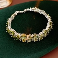 Macro detail of emerald green zircon stones on a silver-plated double-layer bracelet - Green