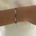 Adjustable silver bracelet with black enamel heart links and white cubic zirconia accents - Black and White Heart Adjustable Bracelet (B487) / Silver
