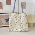 Close-up of quilted cream tote bag featuring vintage rabbit print and purple handle - Lace Purple Rabbit