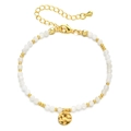 Macro detail of faceted white crystal beads and gold hammered round charm bracelet - White