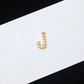Gold plated letter J pendant with micro-paved sparkling crystals on a white card - Letter J