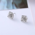 Macro view of geometric diamond-shaped stud earrings with sparkling white cubic zirconia - D4 Silver Geometric