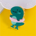 Cute green cartoon dinosaur acrylic badge with high gloss finish on yellow background - Swimming Ring Dinosaur