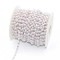 DIY jewelry chain with white faux pearls and gold wire connectors on a plastic spool - Rose Gold