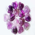Polished natural purple amethyst heart-shaped stones arranged in a circular pattern - Amethyst