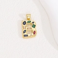 Detailed macro view of a gold-toned letter B pendant with colorful zircon crystal stones - Letter B