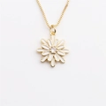 Detailed view of daisy pendant necklace with white enamel petals and golden box chain - White