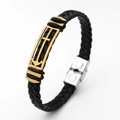 Detail view of black woven leather bracelet with gold anchor and cross charm and silver clasp - Anchor Cross