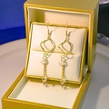 Elegant gold fringe earrings with twisted geometric frames and sparkling cubic zirconia - Twisted Geometric Square Zircon (E3421)