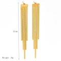 Detail view of 11cm long 18k gold-plated blade chain tassel earrings with 8g weight specs - Gold