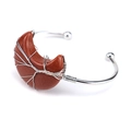 Detail of silver wire-wrapped red sandstone crescent moon on handmade open bangle - Gold Sandstone