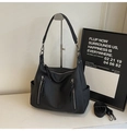 Detail view of black lychee texture leather hobo bag with tassel zippers and silver hardware - 32cm x 13cm x 24cm / Black