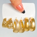 Macro detail of gold-tone earring set featuring hammered, grid, and polished textures - 14 Kc Gold 4203