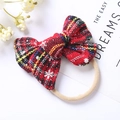 Detail of red plaid Christmas bow headband with snowflake pattern and elastic soft nylon band - 8.5x6.5cm / Ginger Plaid