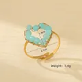 Macro shot of handmade heart ring with blue faceted beads and gold wire wrap details - Heart Beaded Style