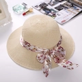 Elegant beige straw sun hat with floral ribbon bow and wide brim for summer travel - Ribbon Style Beige